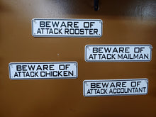 Load image into Gallery viewer, 4 BEWARE OF ATTACK SIGNS ON A BROWN WALL. THEY ARE BLACK WORDS ON WHITE METAL. 12 INCHES LONG BY 3” HIGH. SAYINGS ARE ‘BEWARE OF ATTACK ROOSTER, CHICKEN, MAILMAN, AND ACCOUNTANT.