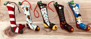 Stocking shaped felt Christmas ornaments. Embellished with whipstitching, beads and more. 
