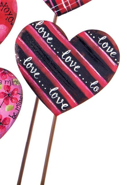 metal heart shaped plant stake for valentine's day.  This is red and black striped with love...love....love written in every other black stripe.  There is a hint of glitter for sparkle
