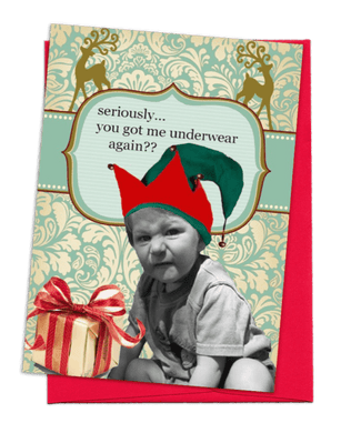 GREETING CARD | BRIGHT, CHRISTMAS-RED ENVELOPE. | TEAL WITH WHITE FLORAL BEHIND/TEAL STRIPE ACROSS AND 2 FANCY, TAN DEER ON TOP | YOUNG BOY WITH SHORT-SLEEVED SHIRT AND SHORTS/MAKING UGLY FACE/WHITE CHRISTMAS PRESENT WITH RED AND GOLD RIBBON | WORDS: OUTSIDE, “SERIOUSLY…YOU GOT ME UNDERWEAR AGAIN??” INSIDE, “…MAY ALL YOUR HOLIDAY WISHES COME TRUE…”