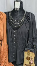 Load image into Gallery viewer, This beautiful contemporary blouse will become one of your favorites, you&#39;ll want one in every color offered. It features a ruffled neck line, smocked front with button closures, and long crochet bell sleeves. 100% rayon fabric. Machine washable. Import. Made in the USA