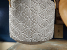 Load image into Gallery viewer, GREY, HANGING, CEMENT, 3.5” PLANTER WITH GEOMETRIC FLORAL DESIGN EXTERIOR, AND A STRONG, 3-POINT ROPE HANGER. DRAINAGE HOLE.