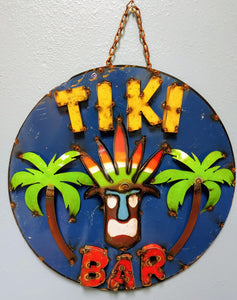 Heavy gauge round metal sign.  Bright blue background accented wit raised lettering in yellow and red.  Warrior chief with head dress and palm trees.
