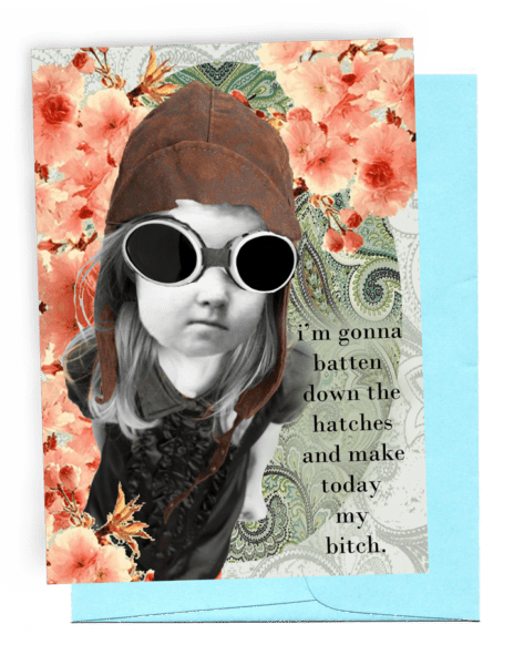 GREETING CARD | LIGHT BLUE ENVELOPE. | BACKGROUND: DOLLAR-COLORED, FLEUR-DE-LIS/BRIGHT PINK FLOWERS | GIRL WEARING OLD-FASHIONED, FOOTBALL HELMET-LIKE CAP/LARGE SAFETY GLASSES FOR FLYING | LONG, BLOND HAIR/PUFFED, SHORT-SLEEVED BLOUSE WITH RUFFLED FRONT | LOOKING STUBBORN WITH FIST | WORDS: OUTSIDE, 