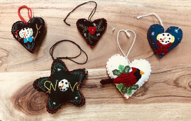 Mini felt heart and star shaped ornaments with whip stitching and embellished designs. Seasonal Christmas designs.