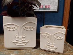 Square ceramic planter with eyebrows, eyes, nose and lips.  Ivory.  6" tall with drainage hole and plug