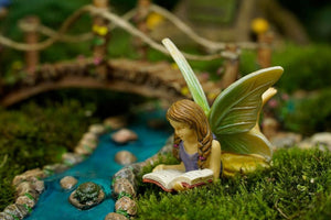 Fairy laying down reading a book mg315