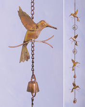 Load image into Gallery viewer, Copper metal rain chain with cut out hummingbirds  in between bells with a metal circle around the bells.  There is a bell at the bottom of the rain chain.  