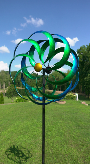 NEW FOR 2020. THIS 7 FEET TALL BLUE KINETIC WIND SPINNER, BY SODONA, IS ON A BLACK METAL POLE. IT IS PAINTED WITH BLUE METALLIC AUTOMOBILE PAINT TO REDUCE FADING AND PEELING. LONG, NARROW, CURVED BLADES. THE SOLAR LIGHT CHANGES COLORS. IT IS METAL CONSTRUCTION WITH SOME ASSEMBLY REQUIRED.