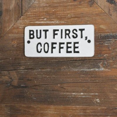 Cast Iron But First Coffee sign.  White background with black raised letters.  Two holes on each side to hang sign.  could be inside or outside.