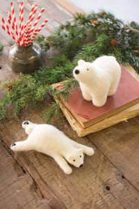 These two felted white polar bear cubs could not be any cuter  This set of 2 polar bears will melt your heart this season. Crafted with felt, 1 bear is chillin' the other is taking in the scenery. Super cute addition to your holiday décor.  Measurements : 6.3'' H x 3.15'' W x 3.15'' D