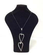 Load image into Gallery viewer, Open Hearts necklace in mottled silvertone metal has two open-hearts that hang on a smooth black  leather-like cord  that does have a lobster claw clap that can add an additional 2&quot; in length however it can easily slip over the head. The hearts can be adjusted to hang at different lengths. 