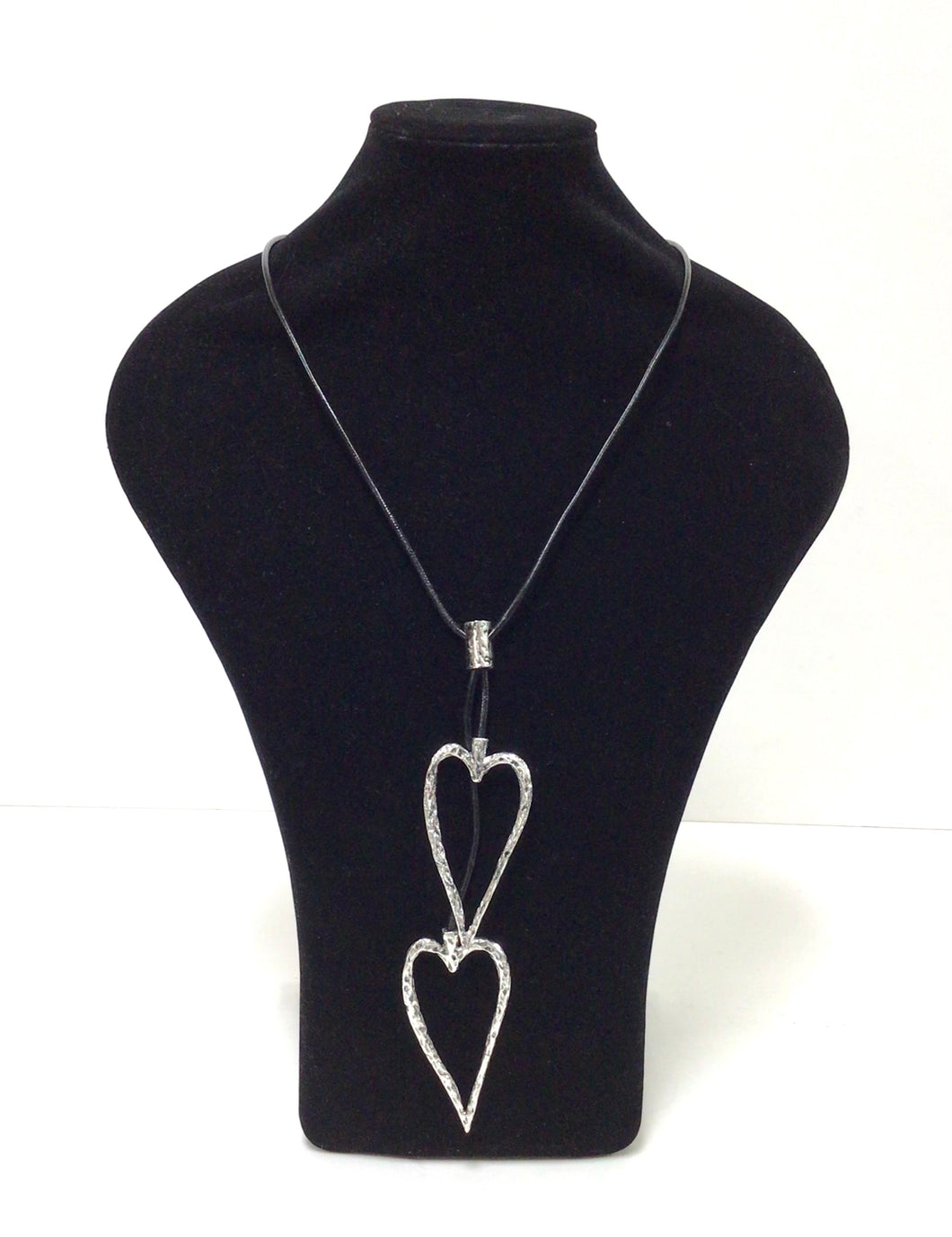 Open Hearts necklace in mottled silvertone metal has two open-hearts that hang on a smooth black  leather-like cord  that does have a lobster claw clap that can add an additional 2