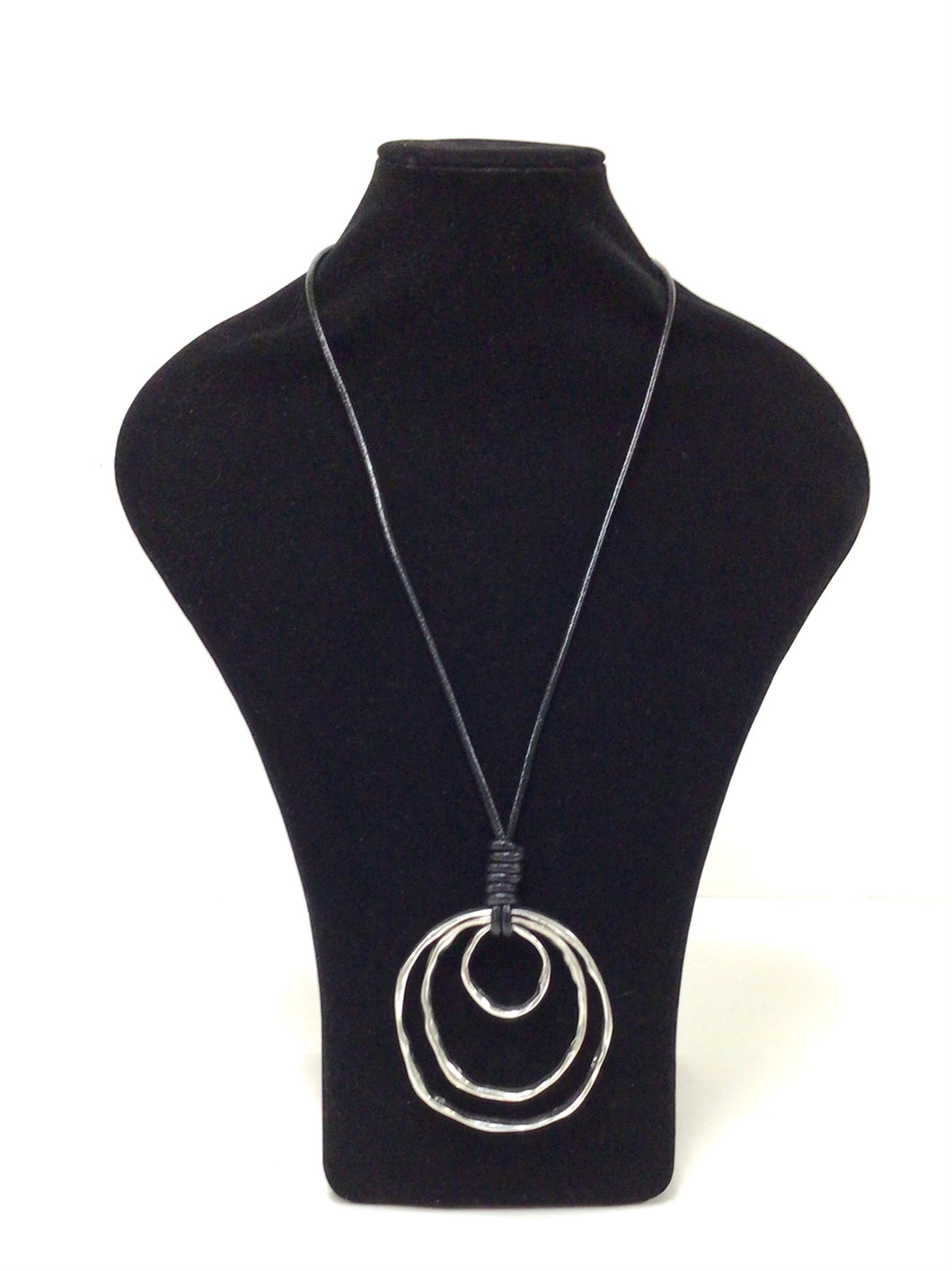 Three silver tone, mottled nested metal circles hang from a 18