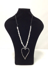 Load image into Gallery viewer, Silvertone open heart approx 2.5Wx3&quot;L hangs from an 18&quot; black cord that is adorned with silver tone beads and several freshwater pearls. The  beads extend on either side of the top of the heart  approximately 6&quot;. the remaining part of the cord is plain. 