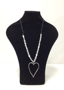 Silvertone open heart approx 2.5Wx3"L hangs from an 18" black cord that is adorned with silver tone beads and several freshwater pearls. The  beads extend on either side of the top of the heart  approximately 6". the remaining part of the cord is plain. 