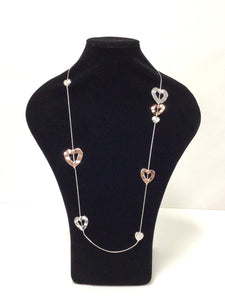 20" necklace is a fine silvertone chain asymmetrically dotted with lovely silvertone, rose goldtone open hearts, and smaller hearts filled with faux mother of pearl. It does feature a clasp that can add an additional 3" in length but can easily slip over the head. 