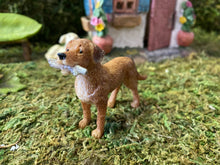 Load image into Gallery viewer, FAIRY GARDEN – RESIN – ‘FETCH’ FAIRY DOG | MG49 | 4.41” T BY 4.25” W BY 4.17” D | ALWAYS READY TO PLAY IN YOUR MINIATURE OR FAIRY GARDEN | LIGHT TAN COAT WITH WHITE CHEST | FINELY DETAILED FUR | WHITE STICK IN ITS MOUTH | FRONT VIEW.