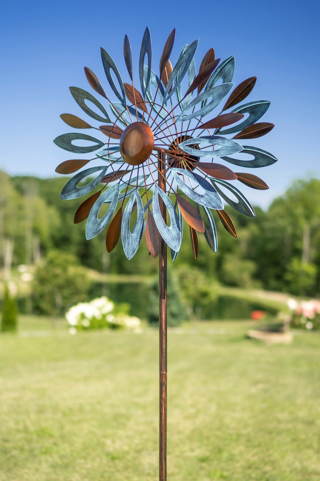 THIS NEW FOR 2021, WINDSLOW, 6’ TALL BY 24” WIDE, KINETIC WIND SPINNER IS PAINTED WITH METALLIC AUTOMOBILE PAINT TO REDUCE FADING AND PEELING. LIGHT BLUE LEAVES ALTERNATE WITH THE COPPER LEAVES. THE BLADES TURN IN 2 DIFFERENT DIRECTIONS. IT IS METAL CONSTRUCTION WITH SOME ASSEMBLY REQUIRED. THIS WILL BE DELIVERED BY UPS GROUND.