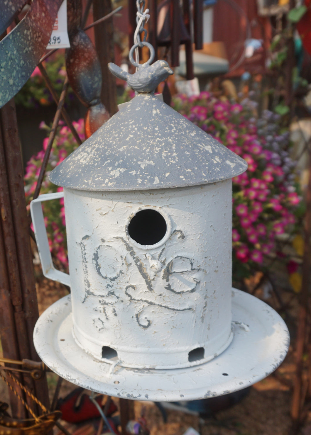 White metal birdhouse with 