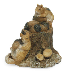 MINIATURE FAIRY GARDEN ACCESSORIES | MG132 | ‘BUSY DAY.’ APPROX. 3” T BY 2” D BY 2.5” L. 2 RESIN CHIPMUNKS WITH ACRONS AND A TREE STUMP. 1 SLEEPING, BACK AGAINST THE STUMP, HOLDING AN ACORN/1 SITTING ON BACK EDGE OF STUMP HOLDING ACORN. SHELL OF AN EMPTY ACORN AT THE BASE. COLORS: CHIPMUNKS TAN WITH BLACK/WHITE STRIPES DOWN BACK; ACORNS TAN SHELL, DARK BROWN ‘CAP, ’ LIGHT TAN INSIDE; STUMP MEDIUM BROWN TO ALMOST WHITE WITH BARK-LIKE DESIGN.