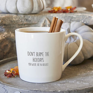 White bone china coffee mug that reads "Don't blame the Holidays your were fat in August