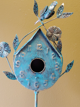 Load image into Gallery viewer, BLUE, PATINA COPPER BIRDHOUSE | ANTIQUE PATINA COPPER FINISH | CLOCK-STYLE PEAKED ROOF /ROUNDED BOTTOM AND PERCH BELOW 2” OPENING/WEATHER AND RUST-RESISTANT | CRAFTED OF METAL LEAVES, VINES, FLOWERS, AND BIRD. WITH A METAL STAND, IT IS 55” T.