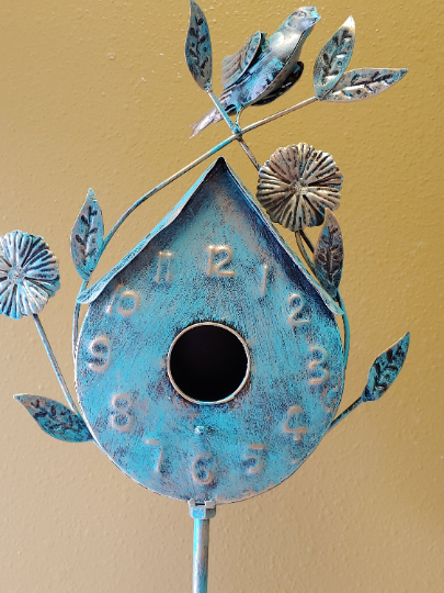 BLUE, PATINA COPPER BIRDHOUSE | ANTIQUE PATINA COPPER FINISH | CLOCK-STYLE PEAKED ROOF /ROUNDED BOTTOM AND PERCH BELOW 2” OPENING/WEATHER AND RUST-RESISTANT | CRAFTED OF METAL LEAVES, VINES, FLOWERS, AND BIRD. WITH A METAL STAND, IT IS 55” T.