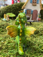 Load image into Gallery viewer, FAIRY GARDEN – RESIN – ‘LITTLE DRAGON’ FAIRY | MG305 | 3” T BY 2” W BY 2” D | 1” STAKE AT BOTTOM | GREEN SCALES/YELLOW-ORANGE WINGS/YELLOW-GREEN RIDGE-LINE SCALES | ON MOSS | BACK SHOWING RIDGE-LINE AND WINGS | ON BACK LEGS WITH YELLOW BUTTERFLY ON ITS NOSE.