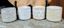 Load image into Gallery viewer, Super cute set of 4 planter pots, gray background  yellow gold accents on the raided patterns.  Including dots, sunbursts, circles and flowers 