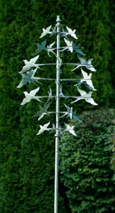 7-TIERED BIRD WIND SPINNER, WHITE METAL, 8’ TALL. 4 GREENISH BIRDS TO EACH TIER, EQUAL-DISTANT APART. EACH TIER FLYS IN OPPOSITE DIRECTIONS. CAN HANDLE STRONG WINDS. SOME ASSEMBLY IS REQUIRED.