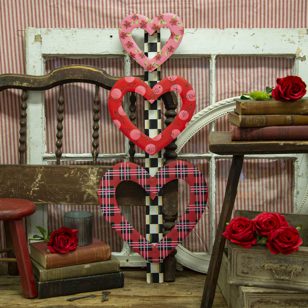red, pink and black floral print, plaid, and polka dot heart stacked garden stake.