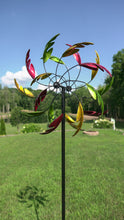 Load image into Gallery viewer, Wind spinner with green, gold and red leaves as blades.