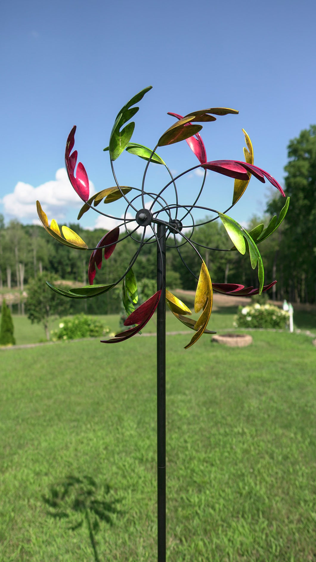 Wind spinner with green, gold and red leaves as blades.