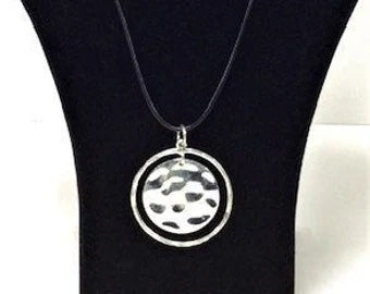 Modern-styled necklace. Metal pendant on a 16