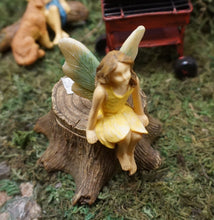 Load image into Gallery viewer, FAIRY GARDEN – RESIN – ‘FAIRY ON STUMP’ | MG322 | 3” T | FAIRY SITTING ON DRK BROWN TREE STUMP, LIGHT BLUE/YELLOW WINGS/BROWN HAIR/ SLEEVELESS, YELLOW DRESS | LIFT HER OFF TO REVEAL HOLLOW TRUNK (HIDE SOMETHING TO SOMEONE TO FIND – MAYBE THE TOOTH FAIRY?) FIGURINE IS SITTING ON MOSS.