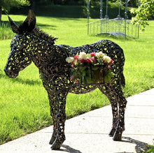 Load image into Gallery viewer, AN ANTIQUE BRONZE-FINISHED, 3 FOOT FILIGREE METAL DONKEY WITH BASKETS. DONKEY IS ON SIDEWALK NEXT TO A LAWN. THERE IS A METAL WALK BRIDGE IN THE BACKGROUND.