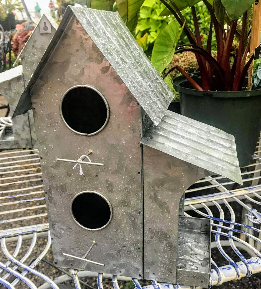 Silver galvanized metal birdhouse condo. There are 2 holes and a side shelter for a suet square