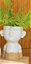 Load image into Gallery viewer, LARGE WHITE CERAMIC KISSING LADY HEAD PLANTER | 8.5” HIGH BY 6.25” WIDE | WHITE WITH SAND-COLORED BOTTOM | SITS ON 2 LIGHT TAN WOODEN BLOCKS WITH FERNS PLANTED IN IT | NOSE, EARS, AND PUCKERED MOUTH.